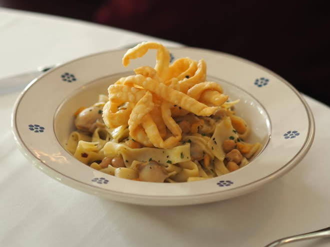 Tagliatelle with chickpeas under a nest of fried pasta.